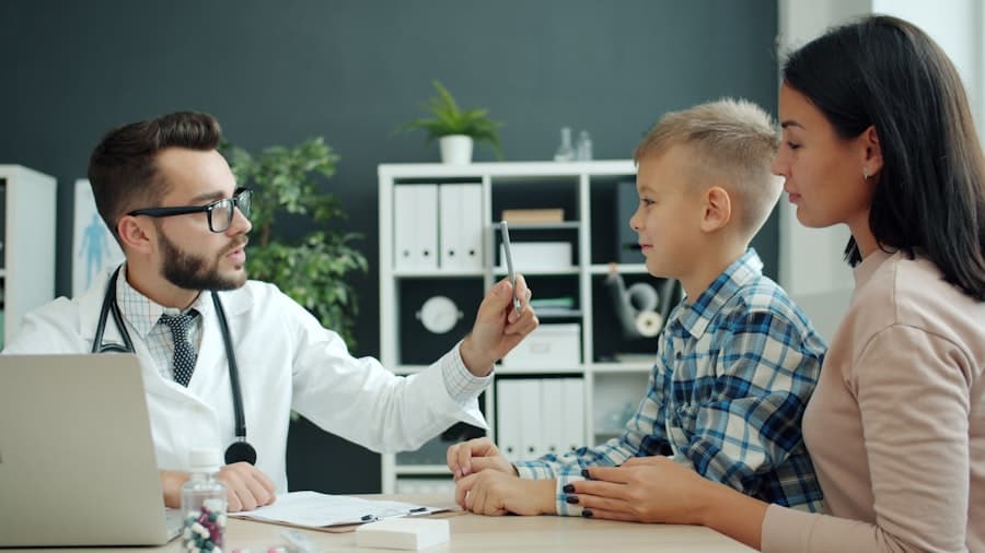 Doctor examining a young boy with his mother present